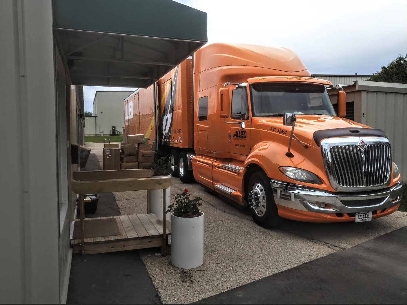 A moving truck backed up to the covered loading area at Tuck-A-Way Storage in Middleton, Wisconsin